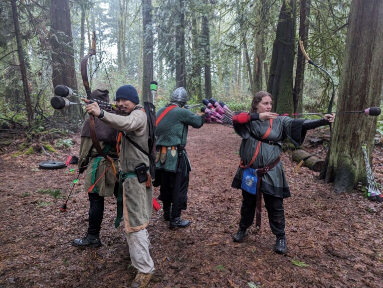 Four archers in a circle, backs to one another, bows raised